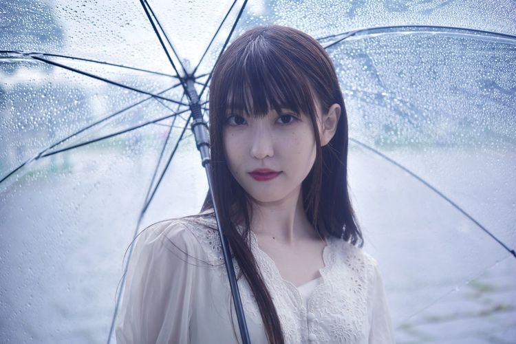 Portrait of a beautiful young woman in rain
