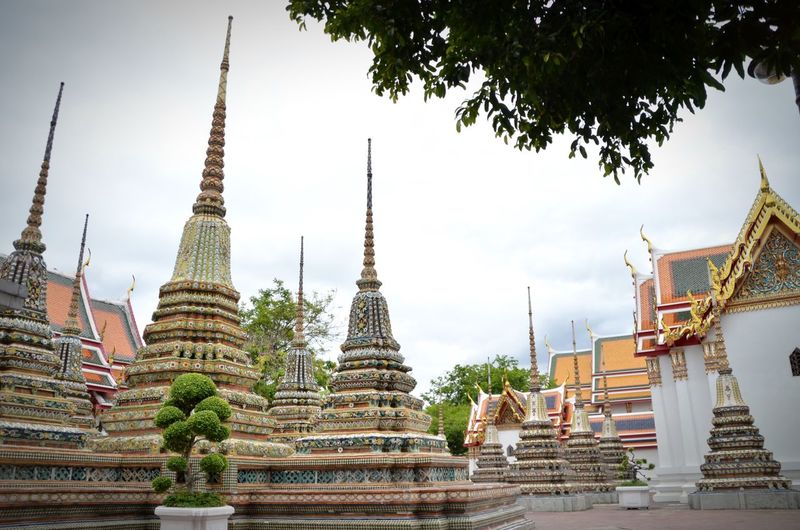 Pagodas in wat pho against sky