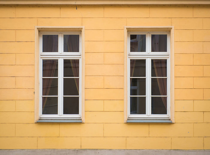 White window on brick yellow wall
