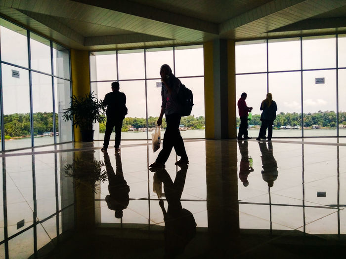 Silhouette people reflecting on floor