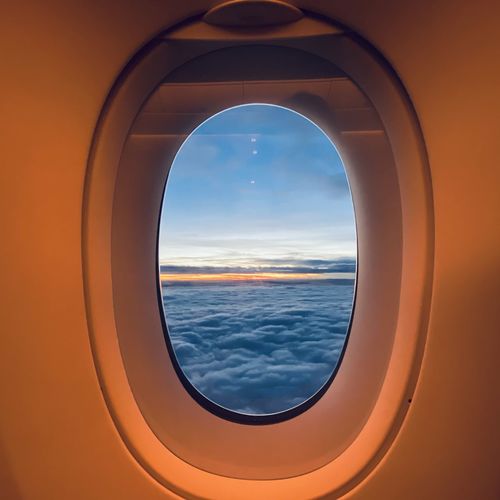 View of sunrise seen through airplane window