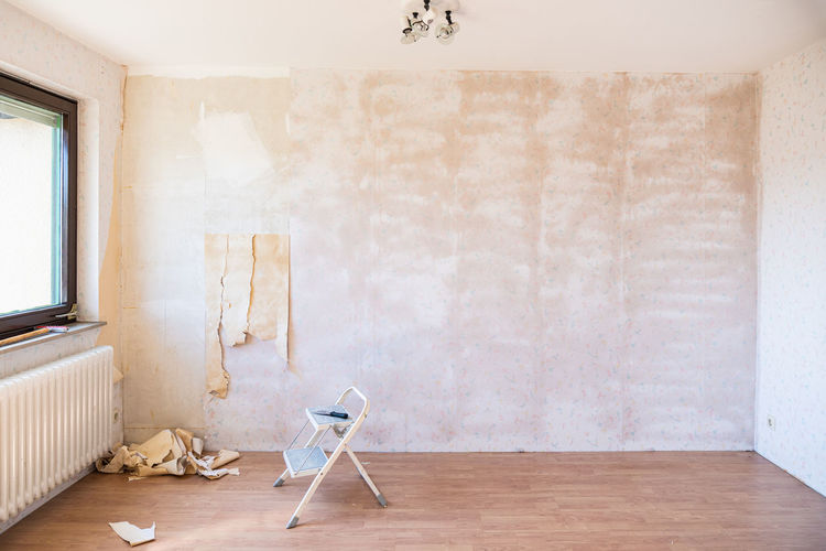 Home renovation project, removing old wallpaper from wall