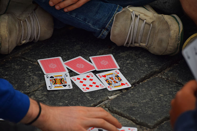 Close-up of people playing cards