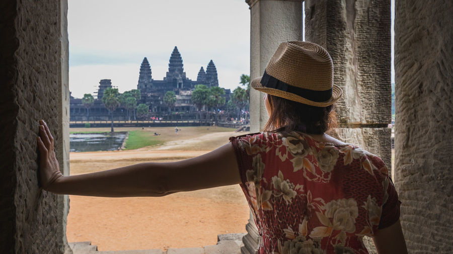 Rear view of woman looking at buildings in city