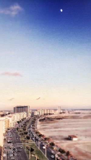 View of cityscape against blue sky