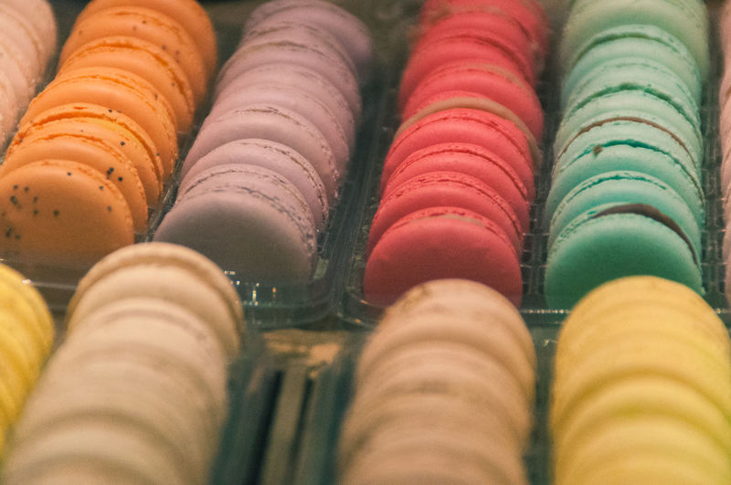 Close-up of colorful macaroons in containers