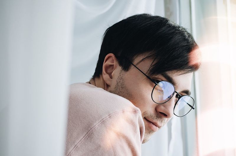 EyeEm Selects Eyeglasses One Person Black Hair Indoors Curtain Men Glasses Real People Lifestyles Young Adult Human Face Home Interior Headshot Day Human Body Part Close-up Human Hand One Man Only Mammal People The Week On EyeEm Editor's Picks