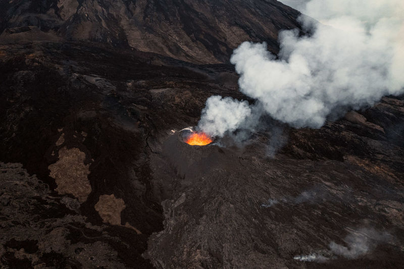 Scenic view of erupting volcano