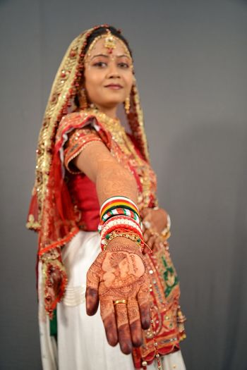 Portrait of smiling woman showing henna tattoo