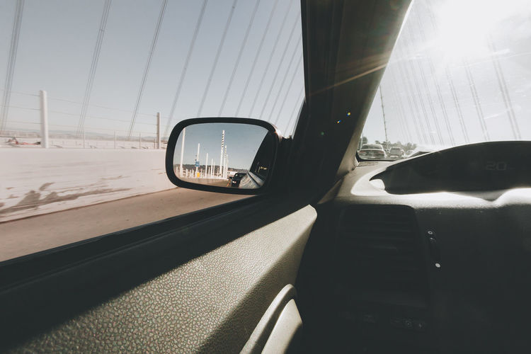 Side-view mirror of car seen through window