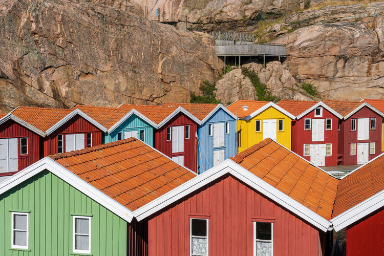 Multi colored houses on rock by building