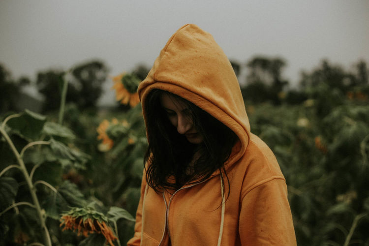 Young woman standing at sunflower farm
