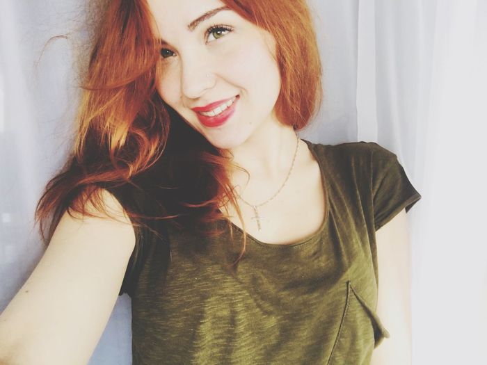 Portrait of smiling beautiful woman with redhead