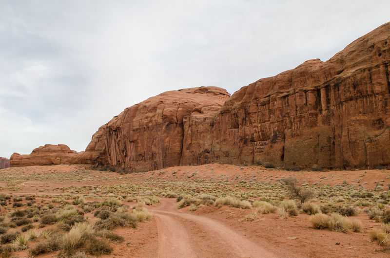 Road leading towards mountain against sky