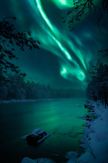 Scenic view of lake against sky at night