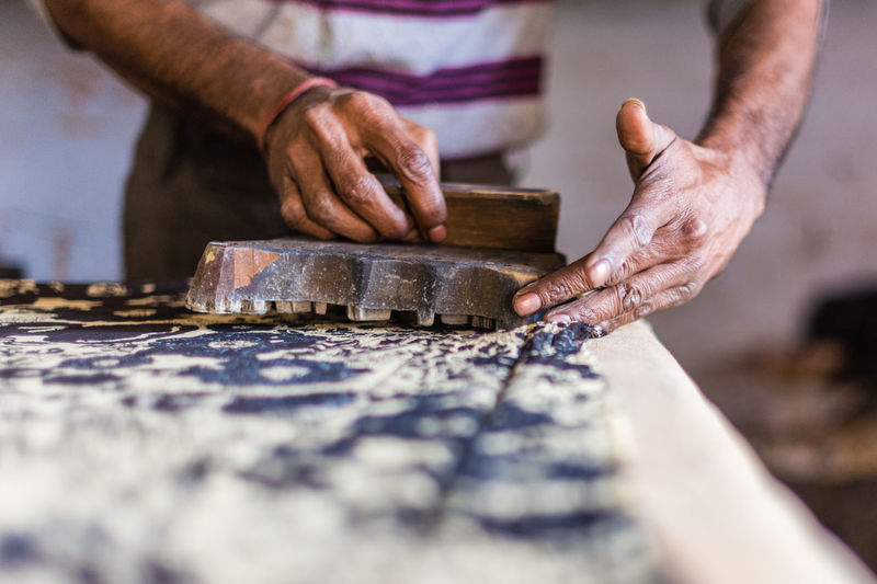 Close-up midsection of manual worker working at workshop
