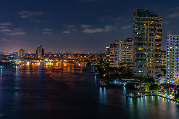 Illuminated city buildings at waterfront