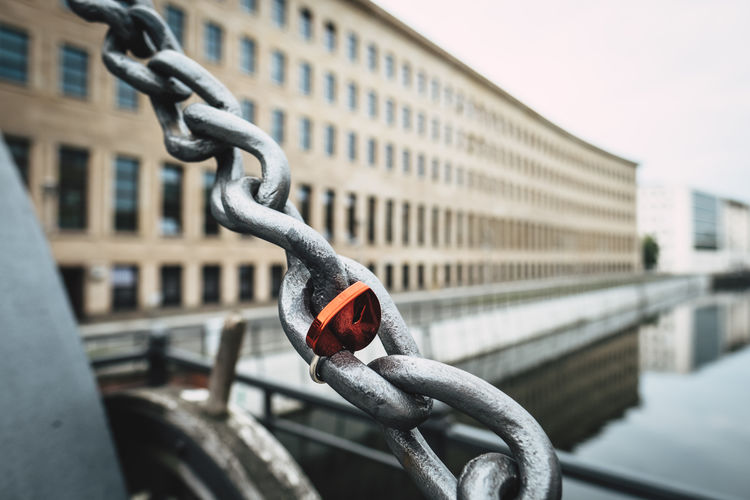Close-up of love lock on chain in city