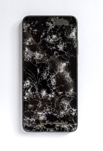 High angle view of broken smart phone