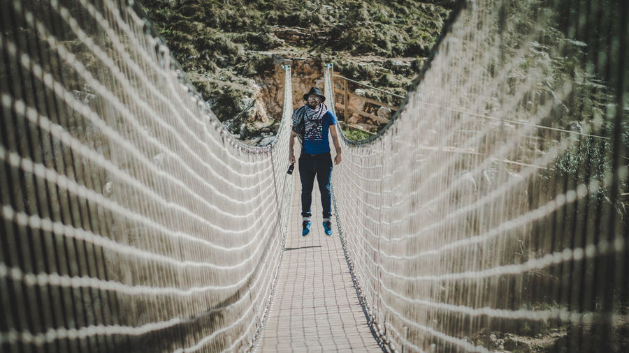 Full length of man jumping on bridge