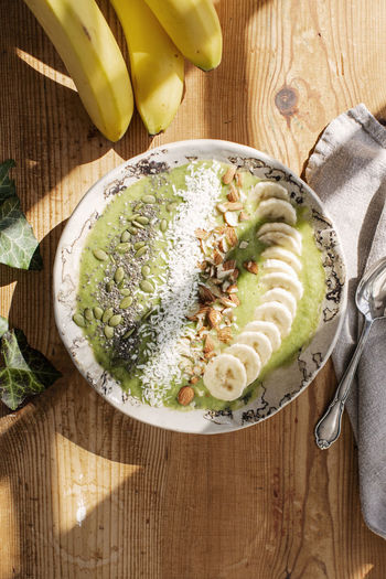 Healthy breakfast with banana, nuts, and seeds in bowl