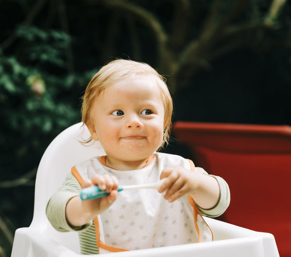 Portrait of cute boy holding baby girl