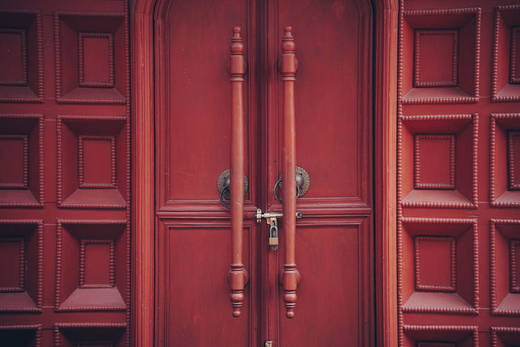 Brown wooden door entrance doorknob handle wall for background