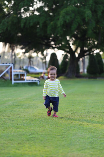 Full length of cute boy walking on grass