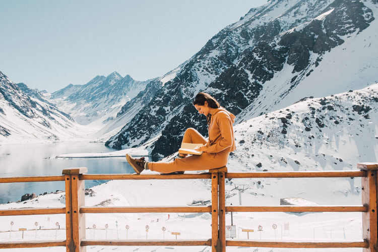 Female tourist reads her book in the sunshine