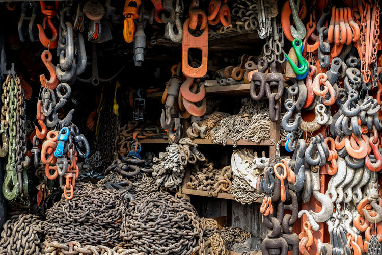 High angle view of various metallic equipment hanging for sale at market stall