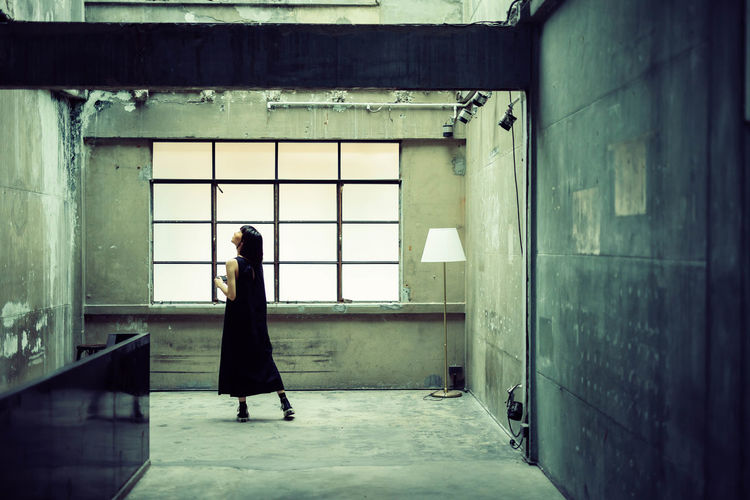 Full length of woman standing in building