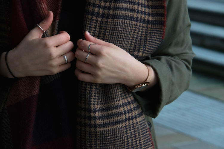 Midsection of woman wearing rings