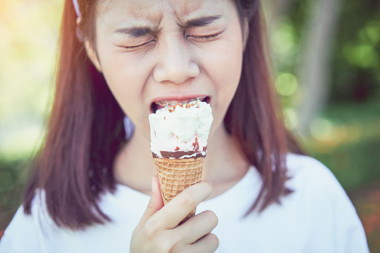 Close-up of young woman eating ice cream cone