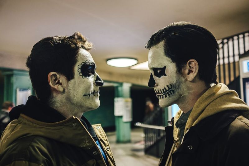 Midsection of two disguised men facing each other