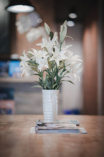 Close-up of white flower vase on table at home