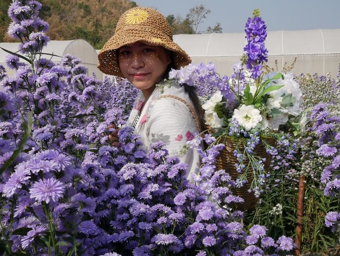 Portrait of smiling woman with purple flowers