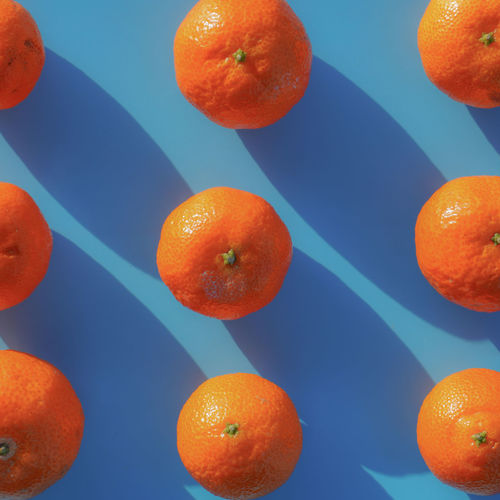 Directly above shot of orange fruit against blue background