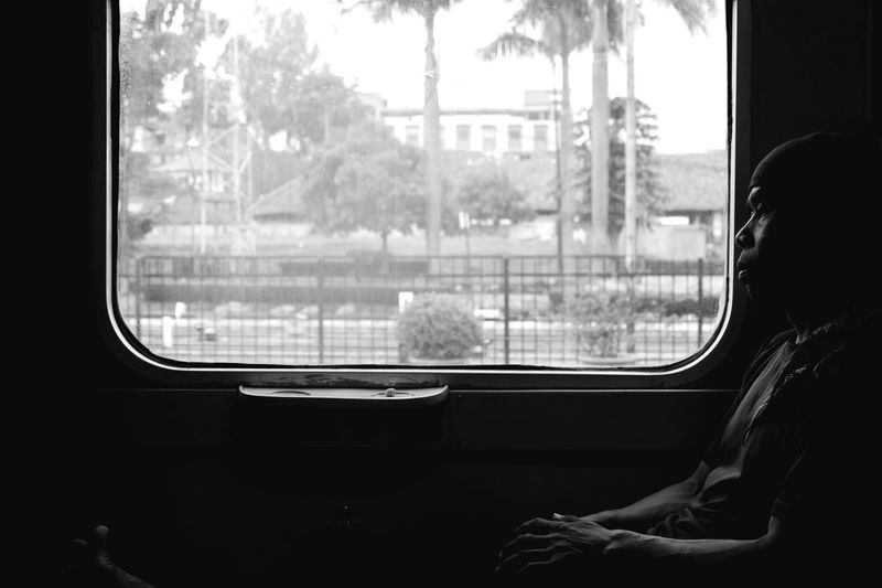 Man sitting by window in train