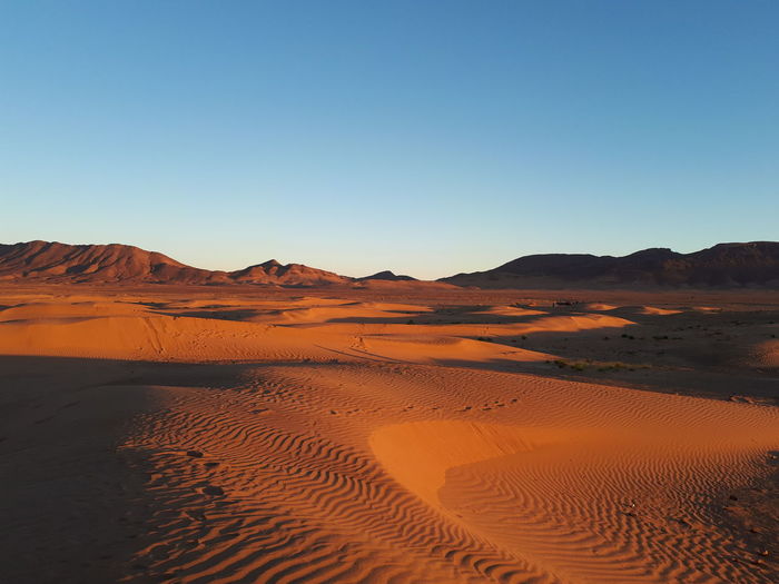 Scenic view of desert against clear blue sky, morocco