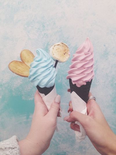 Cropped hands of woman holding ice cream cones