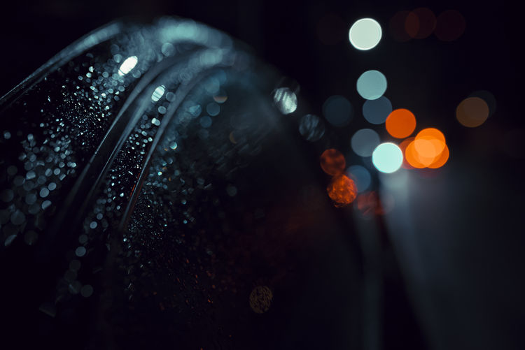 Defocused image of wet car and lights