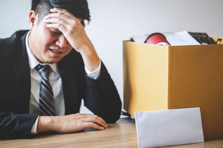 Midsection of man sitting on table