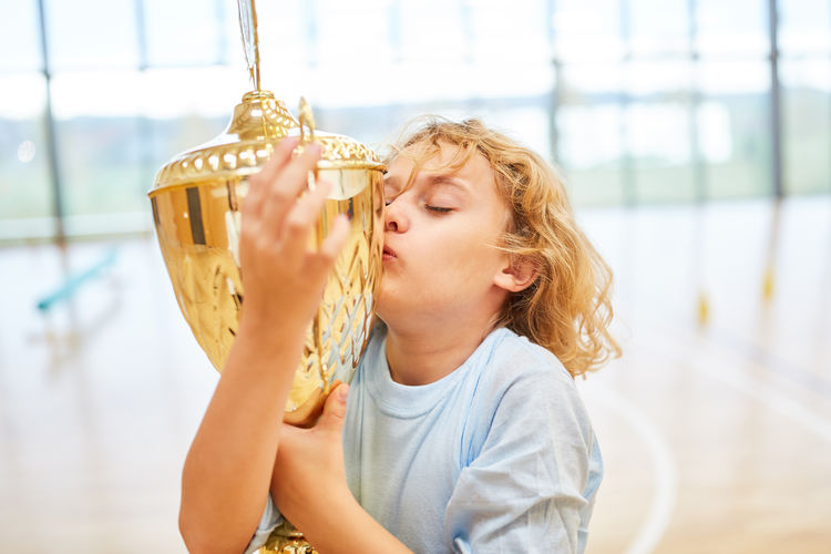 Boy kissing trophy