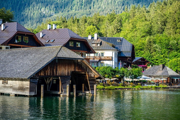 House by lake against buildings