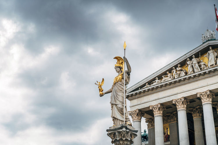 Low angle view of statue against cloudy sky at austrian parliament building