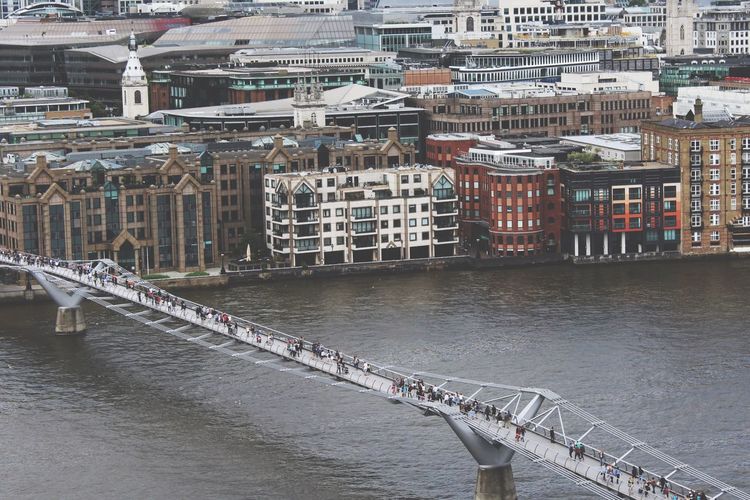 High angle view of people walking on london millennium footbridge over thames river