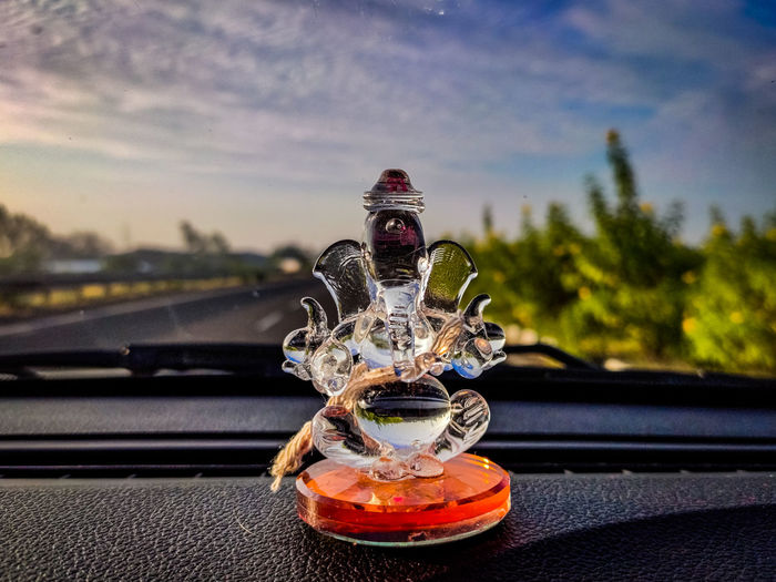 Close-up of ganesh statue on dashboard