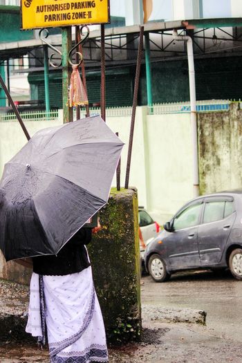 Man working on street in rain