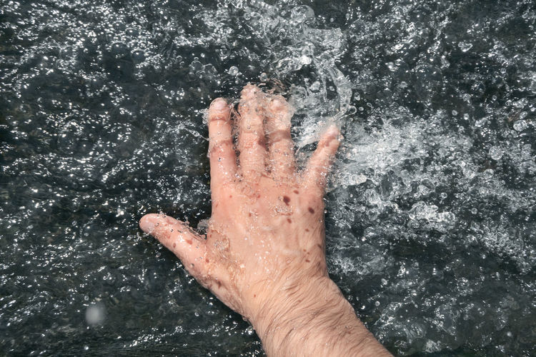 Cropped hand in water