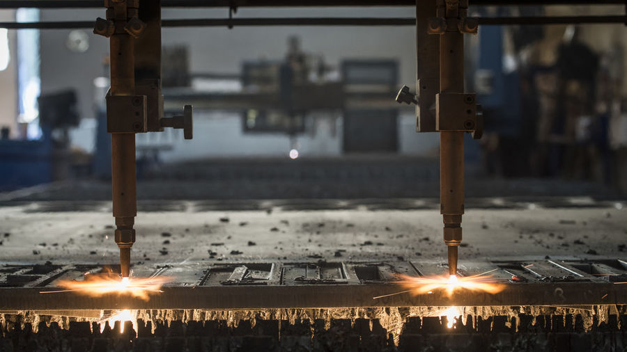 Close-up of machine heating metal in factory